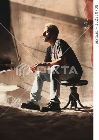 This artwork captures a contemplative moment in an urban setting, reflecting modern city life This artwork captures a contemplative moment in an urban setting, reflecting modern city life 132550708