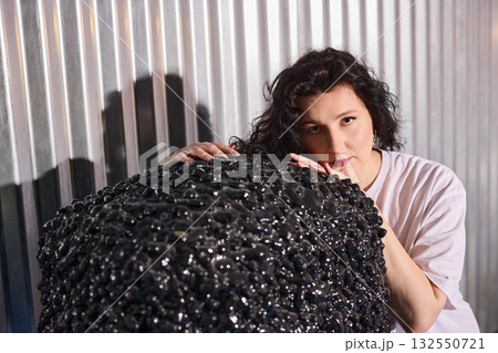 portrait of woman and sculpture, woman poses beside sculpture in intimate studio portrait setting portrait of woman and sculpture, woman poses beside sculpture in intimate studio portrait setting 132550721