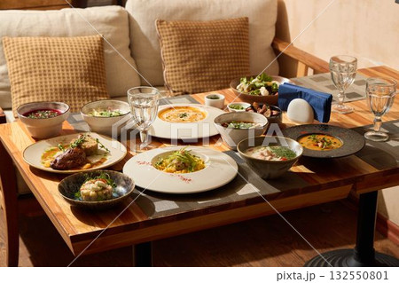 A Truly Gourmet Dinner Setup Featuring a Wide Variety of Diverse Dishes and Elegant Presentation 132550801