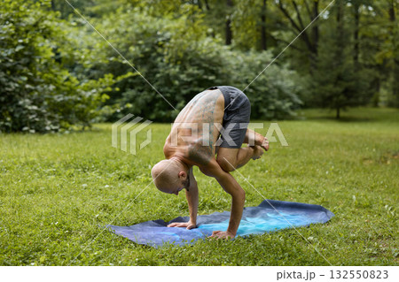 Engaging in a Yoga Practice Set Amidst the Beautiful Serenity of Nature A Balanced Pose on a Mat Engaging in a Yoga Practice Set Amidst the Beautiful Serenity of Nature A Balanced Pose on a Mat 132550823