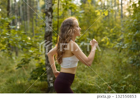 A Woman Running in a Beautiful and Natural Setting Embracing Freedom and Fitness 132550853