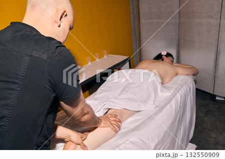 Enjoy a deeply relaxing and revitalizing massage therapy session within a modern spa setting 132550909