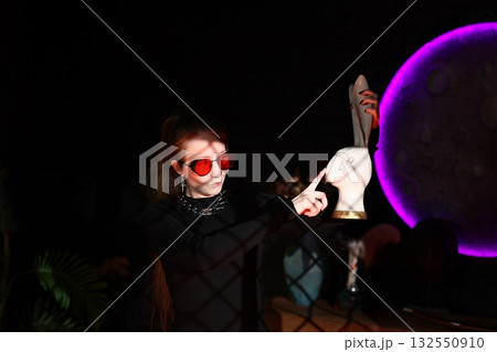 stylish woman with neon accents, caucasian woman in trendy sunglasses showcasing fashionable bunny 132550910