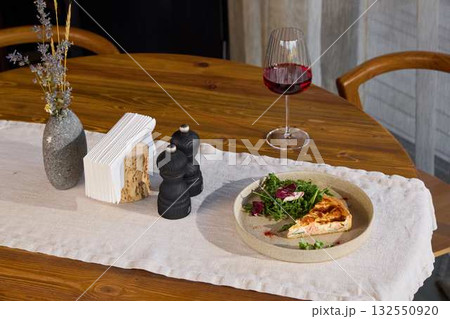 Elegant and Beautiful Dining Table Setup Featuring a Gourmet Dish Accompanied by Wine 132550920