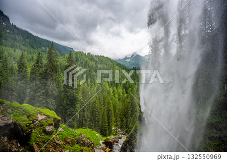 Nestled in the Alps, Johannes Waterfall cascades amid lush greenery near Obertauern. The mist from the fall creates a refreshing atmosphere, perfect for nature enthusiasts. 132550969