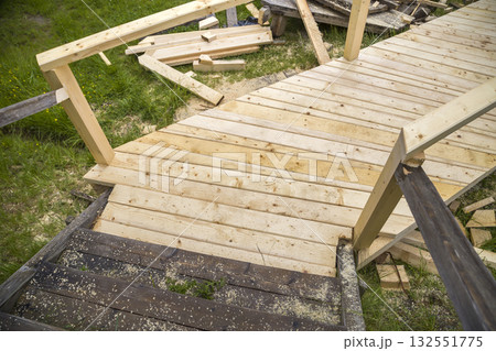 New wooden stairs outdoors. Carpenters work. 132551775