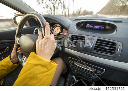 Modern car interior with driver female hands on steering wheel. Safe driving concept. 132551795