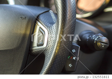 Luxurious car interior. Dashboard and steering wheel in black gray color. Transportation, design, modern technology concept.ultiple Values) Luxurious car interior. Dashboard and steering wheel in black gray color. Transportation, design, modern technology concept.ultiple Values) 132551811