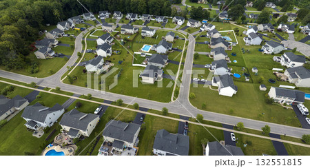Low-density two story private homes in rural residential suburbs outside of Rochester, New York. Upscale suburban houses with large lot size and green grassy lawns in summer season 132551815