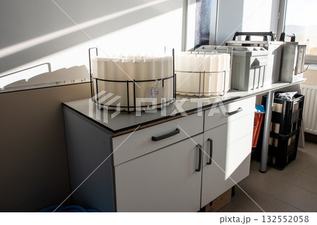 Blue plastic storage boxes on a laboratory counter.Automatic wastewater sampler equipment in laboratory setting. 132552058