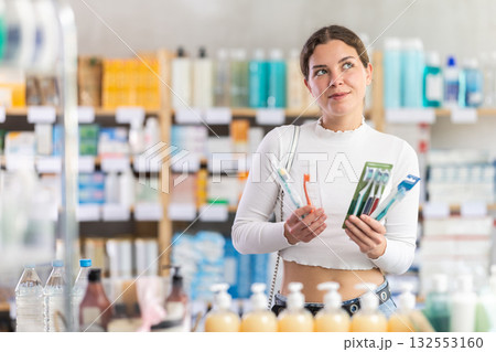 Woman choosing a set of dental nets at the pharmacy 132553160