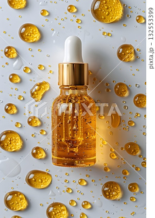 Golden serum in a glass dropper bottle with bubbles, water drops and bright reflections. Minimal luxury beauty concept 132553399