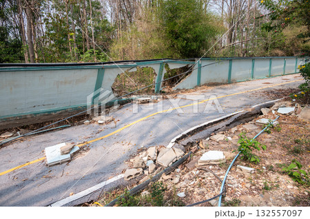 The wall and road collapse due to an earthquake in Chiang Rai province of Thailand. Earthquake causes the building to move with greater amplitude until some part of the building collapses or fails. 132557097