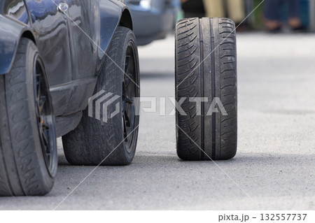New Car Drifting Tires and Worn-Out Tire in Service Pits. Drift race car in service area. New Car Drifting Tires and Worn-Out Tire in Service Pits. Drift race car in service area. 132557737