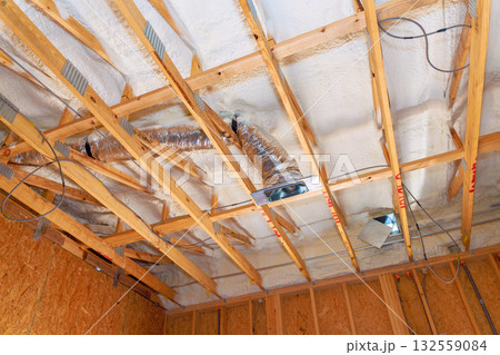 Ventilation ducts insulation are being installed in residential building during renovations. Ventilation ducts insulation are being installed in residential building during renovations. 132559084