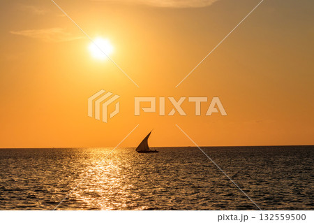 Silhouette of traditional wooden dhow boat in the Indian ocean at sunset in Zanzibar, Tanzania Silhouette of traditional wooden dhow boat in the Indian ocean at sunset in Zanzibar, Tanzania 132559500