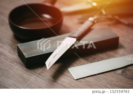 Knife sharpening with whetstone 132559765