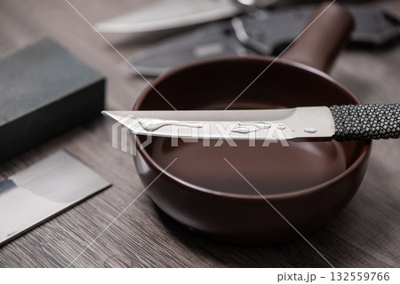 Knife sharpening with whetstone 132559766