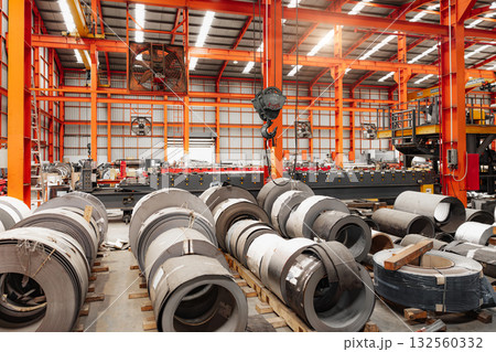 Metal sheet roll, steel sheet roll stock pile storage warehouse heavy industry manufacturing plant. 132560332