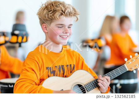 Young person with developmental disabilities enjoys music therapy session playing instrument in inclusive environment Young person with developmental disabilities enjoys music therapy session playing instrument in inclusive environment 132562185