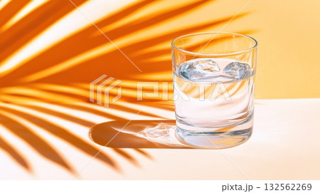 Refreshing glass of clean drinking water on a sunlit table with vibrant shadows creating a serene, healthy atmosphere Refreshing glass of clean drinking water on a sunlit table with vibrant shadows creating a serene, healthy atmosphere 132562269