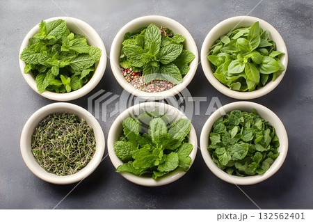 Fresh herbs mint basil thyme in bowls overhead view 132562401