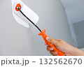 Home repairman paint the walls gray walls, painters use white paint brush rolls. 132562670
