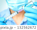 doctor's hand holds a syringe and a blue vaccine bottle at the hospital. Health and medical concepts. 132562672
