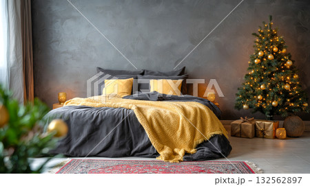A cozy, festive bedroom features a bed with dark grey bedding and bright yellow accents. A lit Christmas tree is on the right, surrounded by presents and lanterns A cozy, festive bedroom features a bed with dark grey bedding and bright yellow accents. A lit Christmas tree is on the right, surrounded by presents and lanterns 132562897