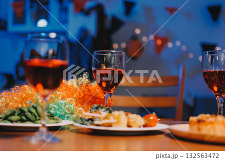 Joyful office Halloween party with coworkers in costumes, celebrating with drinks and laughter, fostering teamwork and festive spirit 132563472