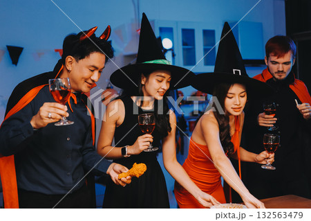 Joyful office Halloween party with coworkers in costumes, celebrating with drinks and laughter, fostering teamwork and festive spirit Joyful office Halloween party with coworkers in costumes, celebrating with drinks and laughter, fostering teamwork and festive spirit 132563479