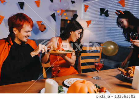 Joyful office Halloween party with coworkers in costumes, celebrating with drinks and laughter, fostering teamwork and festive spirit Joyful office Halloween party with coworkers in costumes, celebrating with drinks and laughter, fostering teamwork and festive spirit 132563502