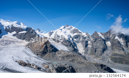 Majestic Piz Bernina rises above the glacier-filled landscape of the Swiss Alps. The clear blue sky complements the towering peaks and rugged terrain at this high-altitude location. Majestic Piz Bernina rises above the glacier-filled landscape of the Swiss Alps. The clear blue sky complements the towering peaks and rugged terrain at this high-altitude location. 132564174