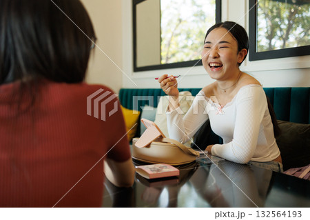 women talking with friend while make up sitting enjoy talking laughing together candid moment 132564193