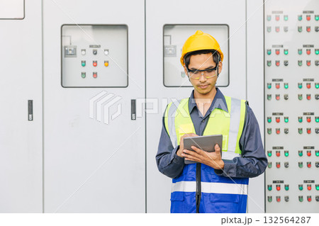Professional Electrician Engineer man working check service electricity switch cabinet with tablet Professional Electrician Engineer man working check service electricity switch cabinet with tablet 132564287