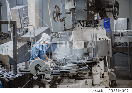 Quiet factory, plant worker cleaning production line convey belt prepare to close food factory Quiet factory, plant worker cleaning production line convey belt prepare to close food factory 132564307