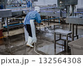Quiet factory, plant worker cleaning production line convey belt prepare to close food factory 132564308