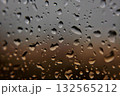 Raindrops on Window with Sunset Colors 132565212