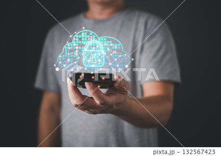 A person in a gray shirt holds a smartphone displaying a glowing cloud with a lock icon, symbolizing computer security, cloud solution, backup, and digital network data protection technology. A person in a gray shirt holds a smartphone displaying a glowing cloud with a lock icon, symbolizing computer security, cloud solution, backup, and digital network data protection technology. 132567423
