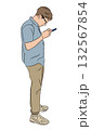 Outline vector illustration of one man with glasses standing and looking intently at his smartphone. Concept of mobile technology and digital focus 132567854