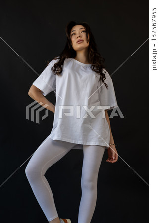 Ecommerceready photograph featuring confident model wearing basic activewear in studio setting 132567955