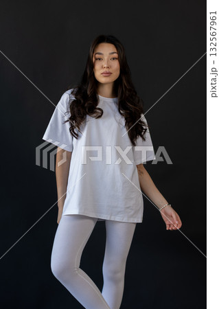 Ecommerceready photograph featuring confident model wearing basic activewear in studio setting 132567961