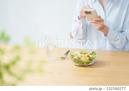 サラダを食べる女性・スマホ サラダを食べる女性・スマホ 132568277