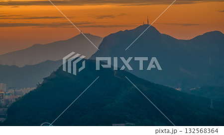 Oct 26 2025 Golden Sunset Over Mountain Ranges With City Skyline Beneath 132568364