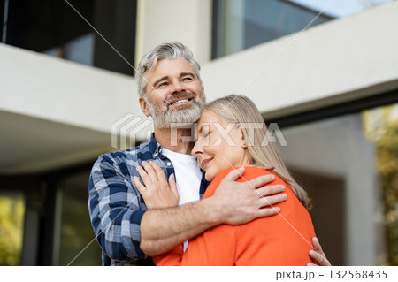 Mature couple feeling happy together and hugging each other Mature couple feeling happy together and hugging each other 132568435