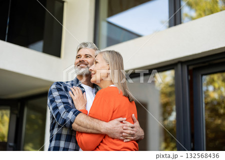 Mature couple feeling happy together and hugging each other Mature couple feeling happy together and hugging each other 132568436
