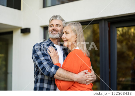 Gray-haired bearded man hugging his wife and smiling happily 132568438