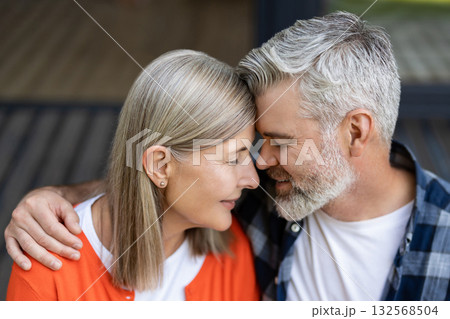 Man and woman sitting together hugging and feeling in love 132568504