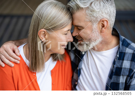 Man and woman sitting together hugging and feeling in love Man and woman sitting together hugging and feeling in love 132568505