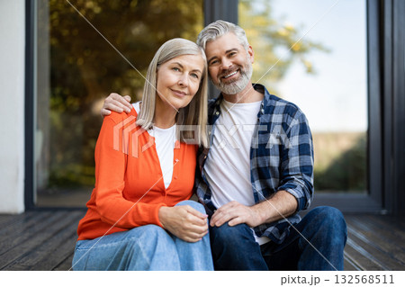 Man and woman sitting together hugging and feeling in love Man and woman sitting together hugging and feeling in love 132568511